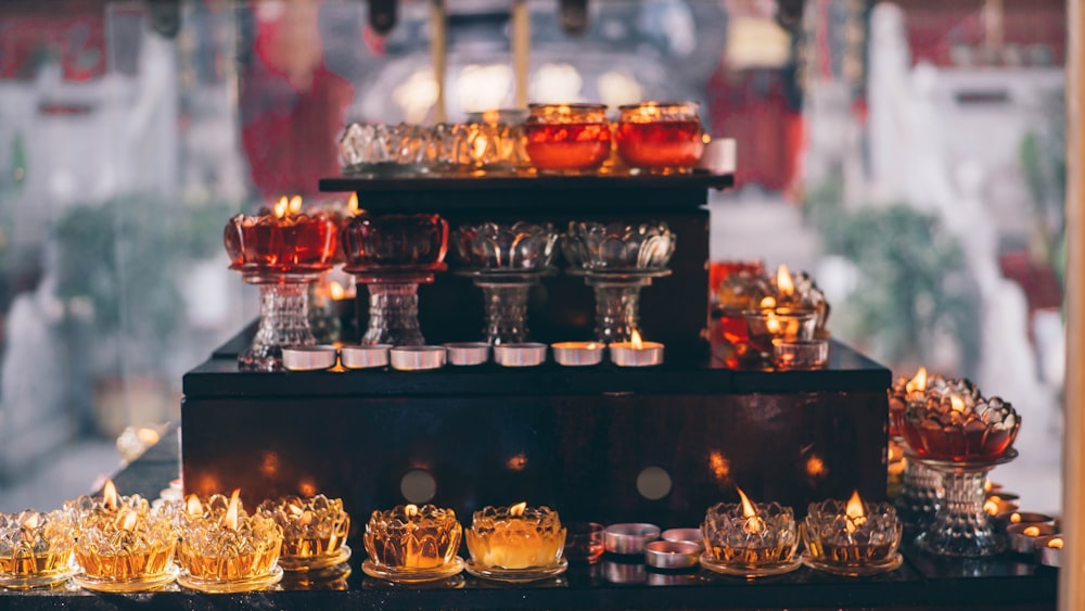 a display of glass dishes and candles on a table