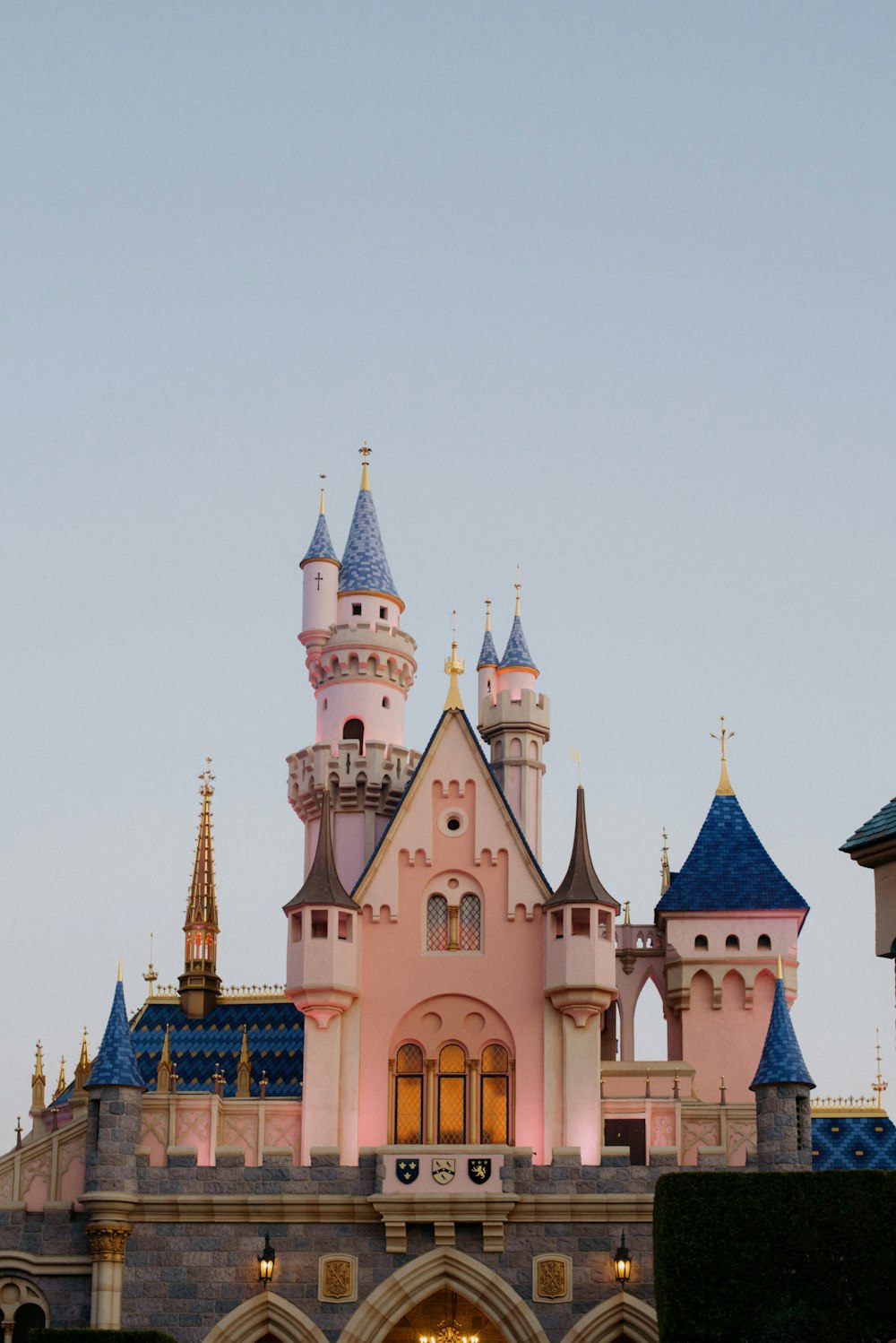 Un gran castillo rosa con un reloj en su lado