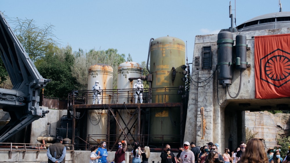 a group of people standing in front of a star wars theme park