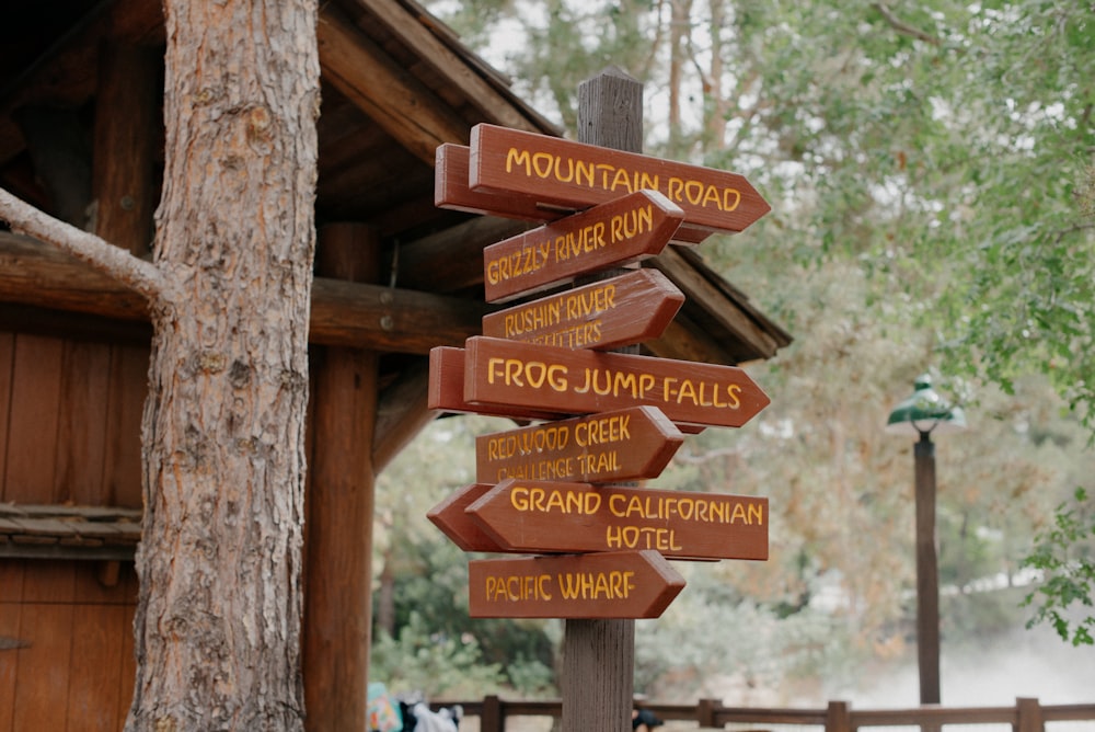 a wooden sign pointing in different directions