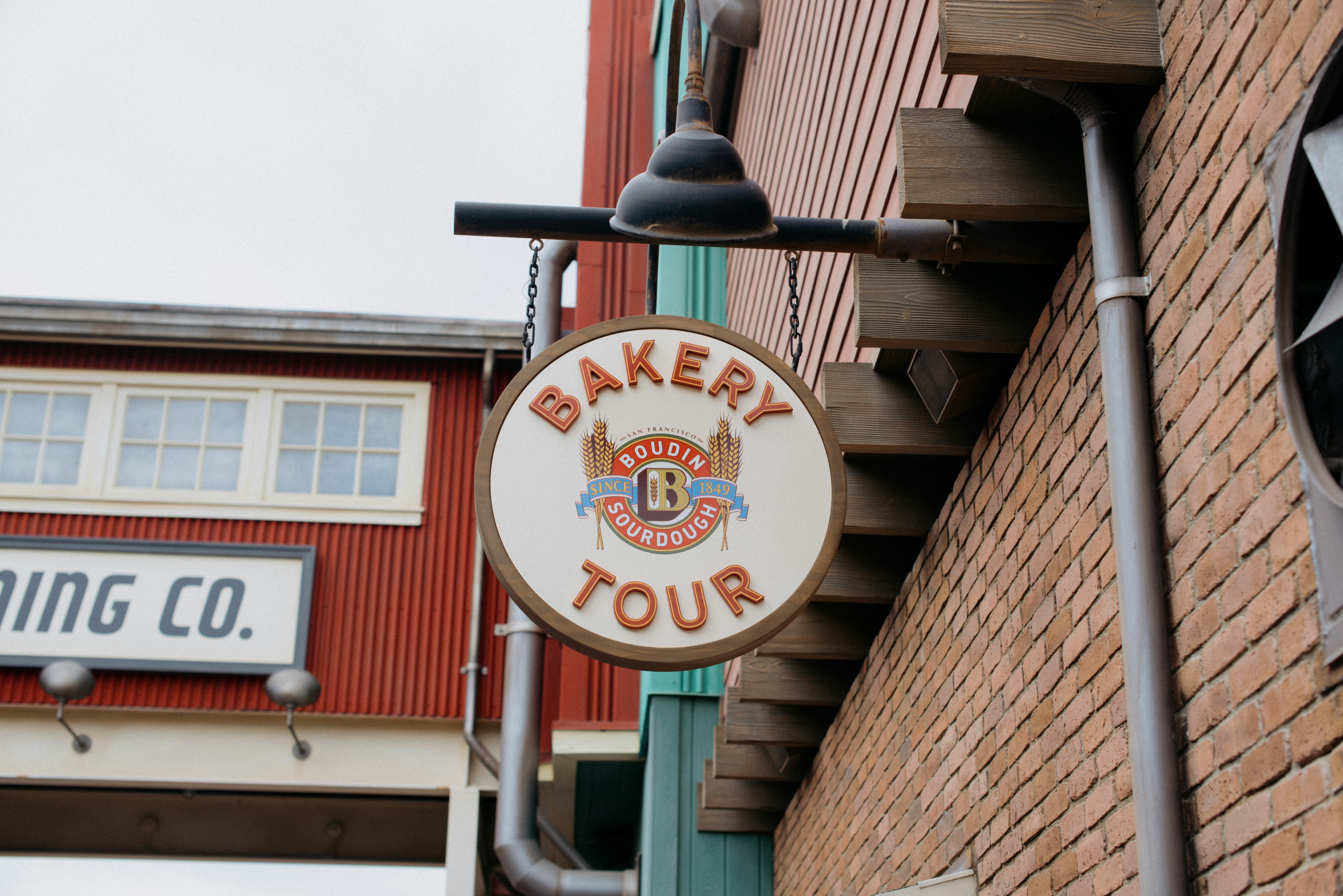 a sign on the side of a building that says bakery tour, 