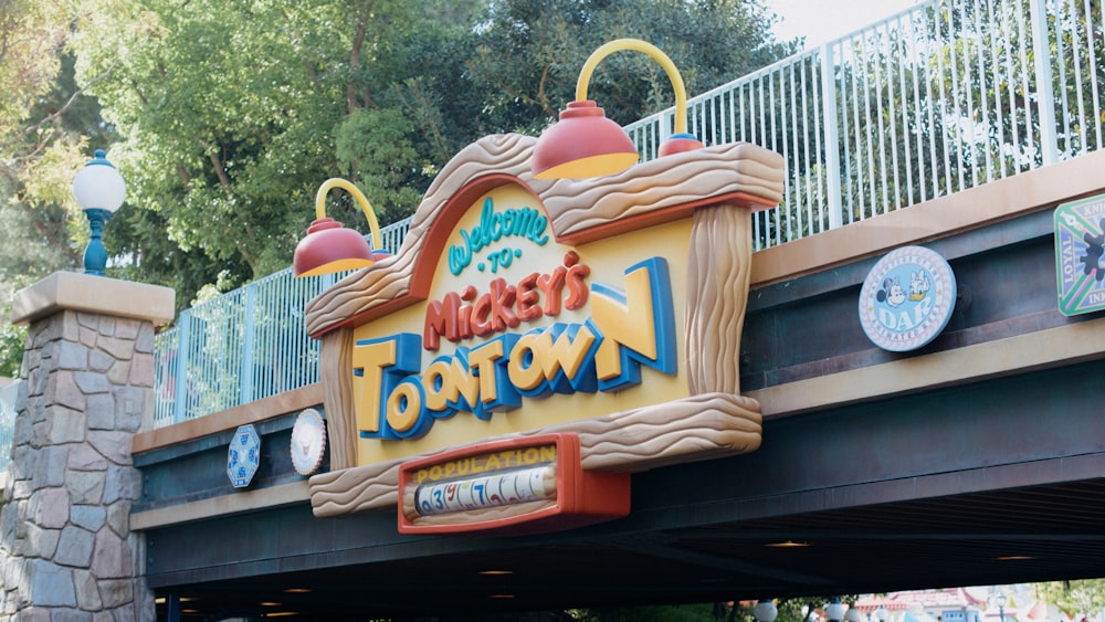 a sign for a fast food restaurant under a bridge