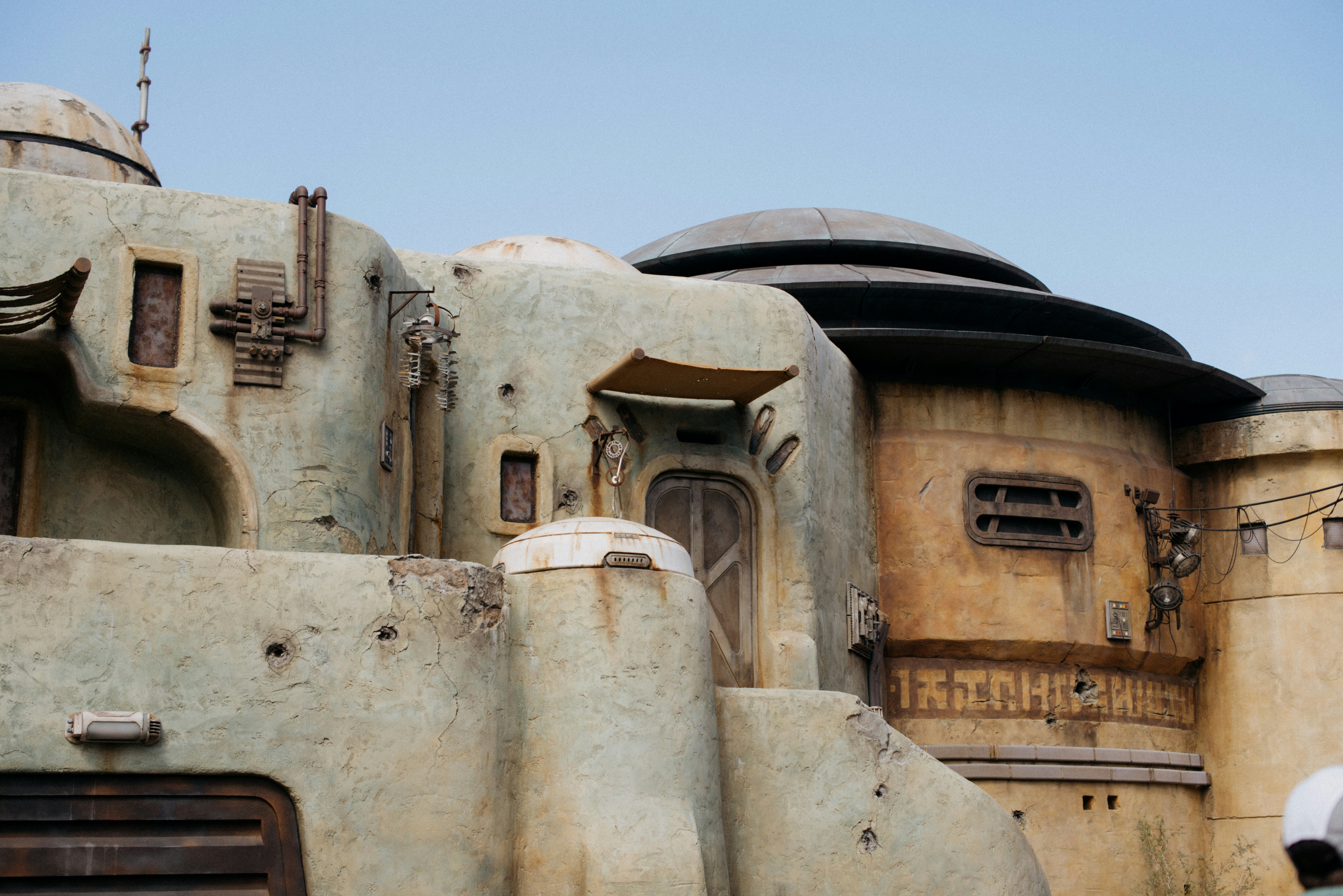 a building made of concrete with a door and windows
