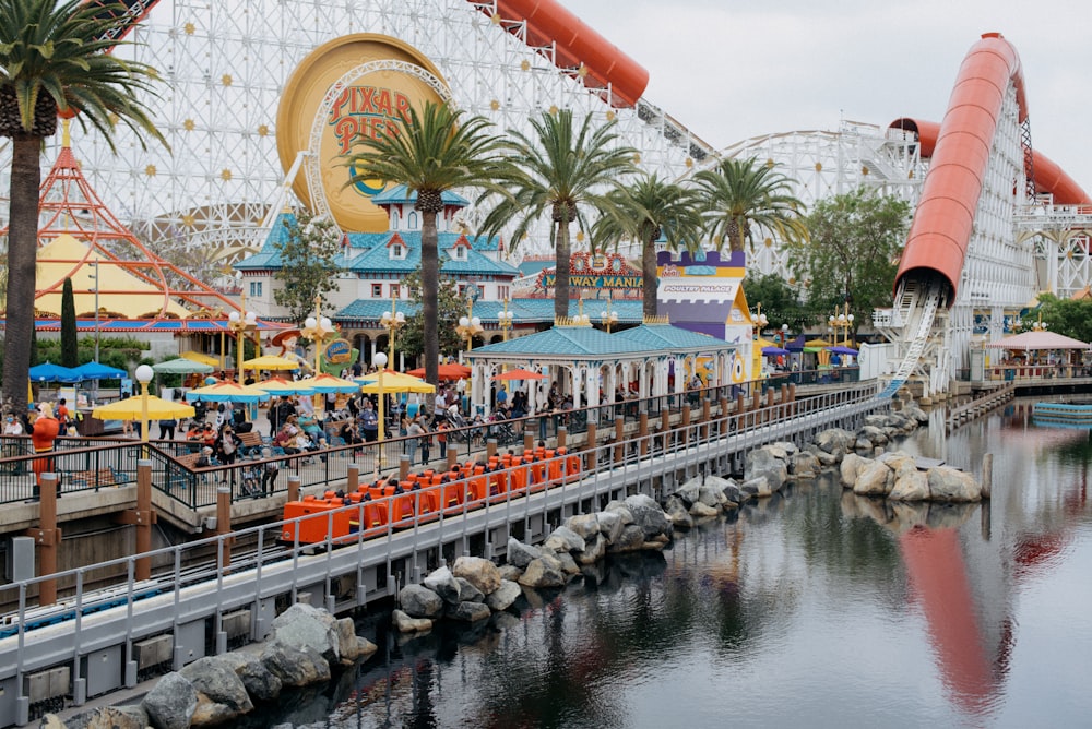 a roller coaster ride next to a body of water