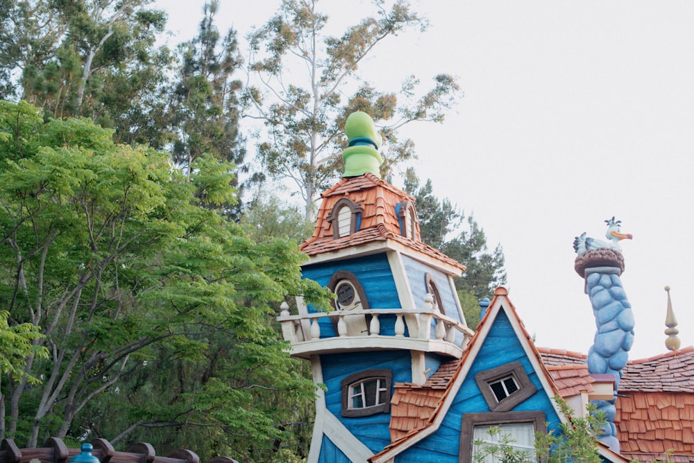 a blue and white house with a green roof