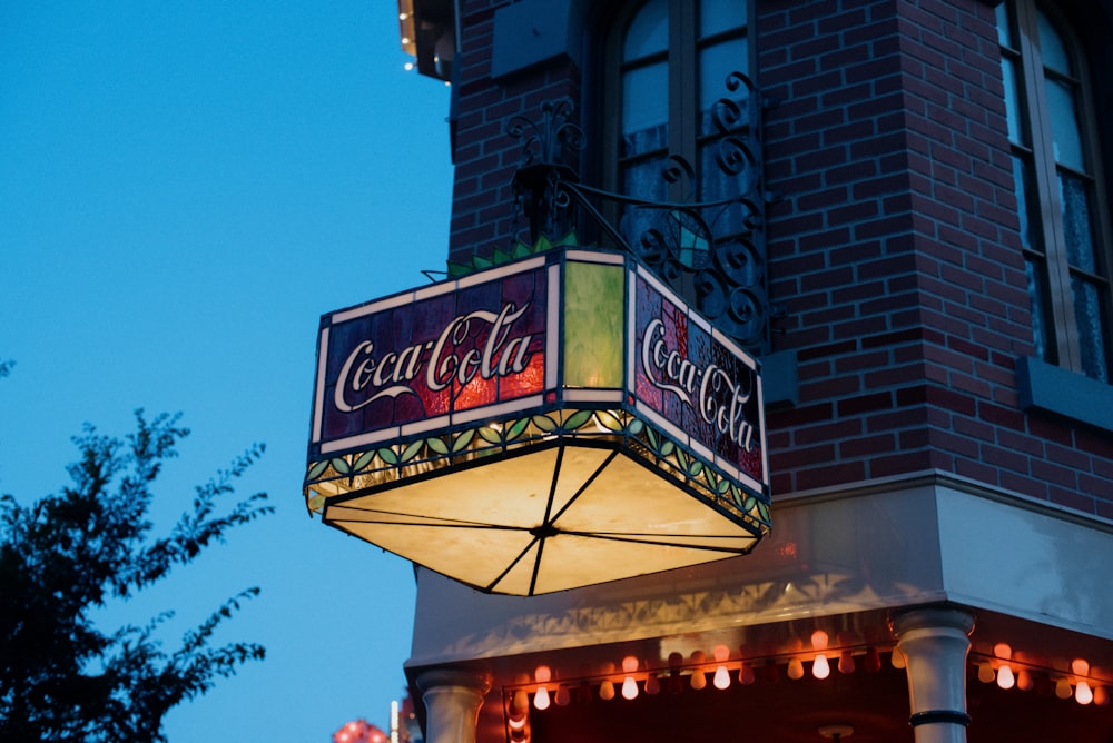 a lit up sign on the side of a building