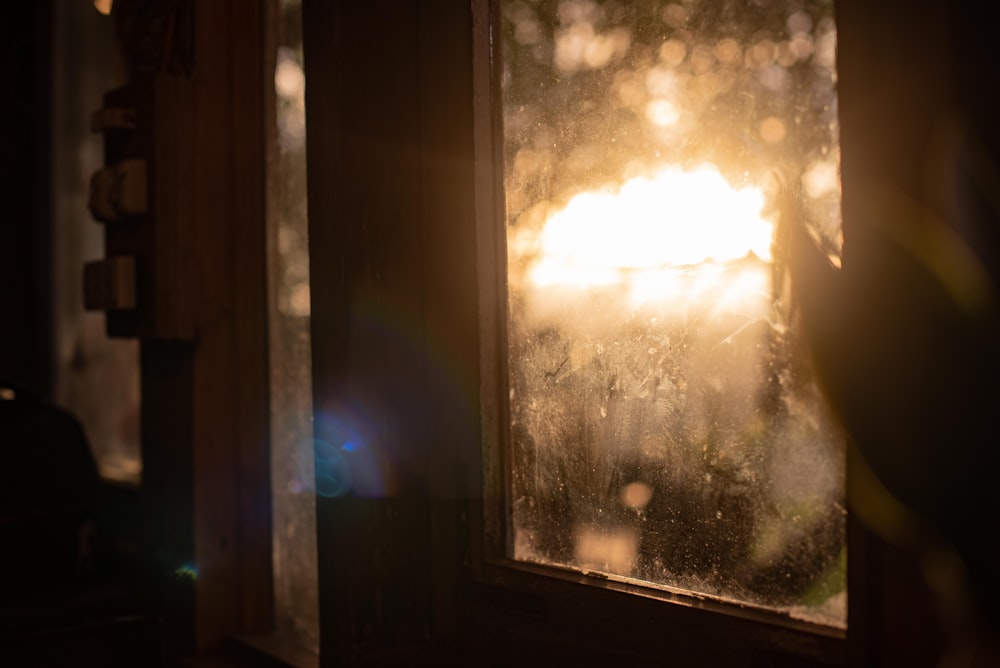 the sun is shining through a window on a rainy day
