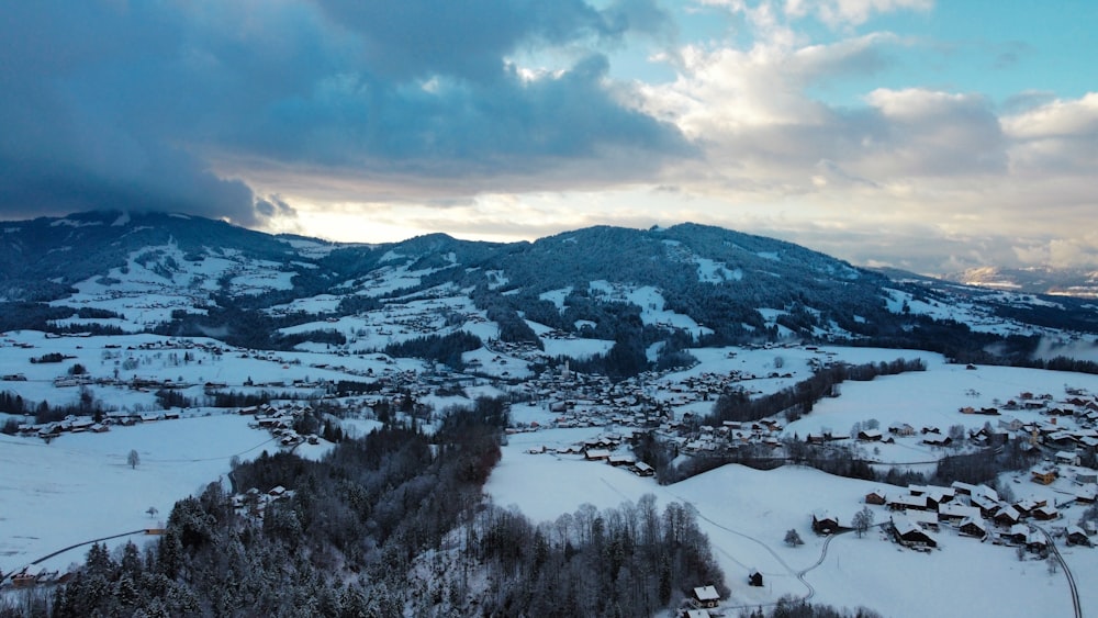 a snow covered mountain with a village in the foreground