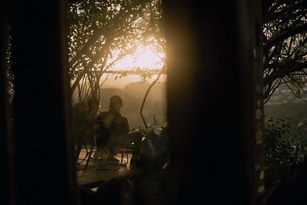 a person sitting in a chair on a porch