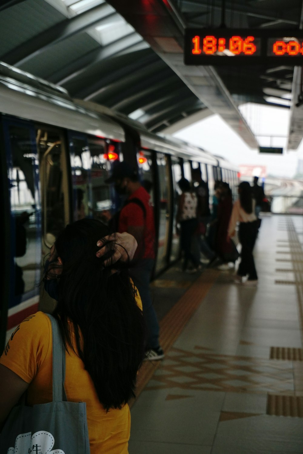 a group of people standing next to a train