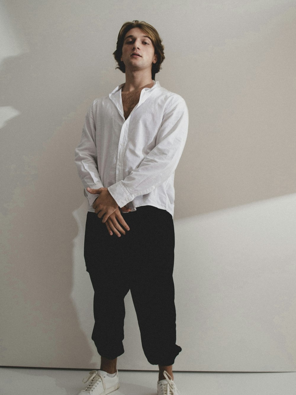 a man in a white shirt and black pants