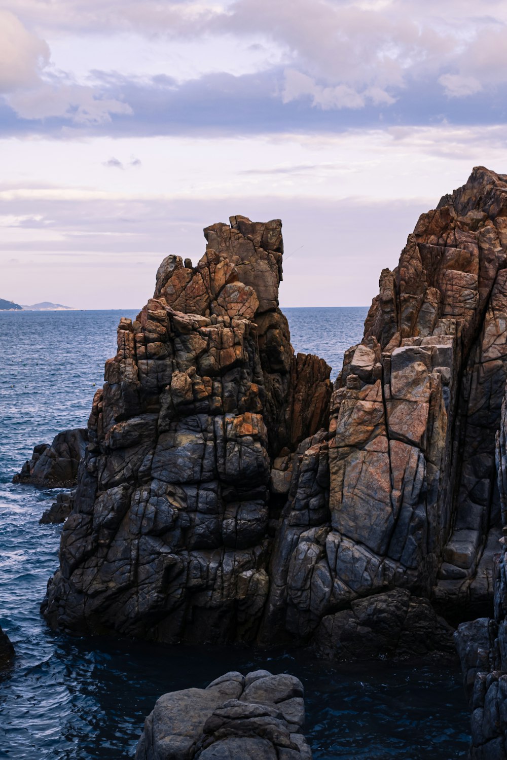 a large rock formation in the middle of the ocean