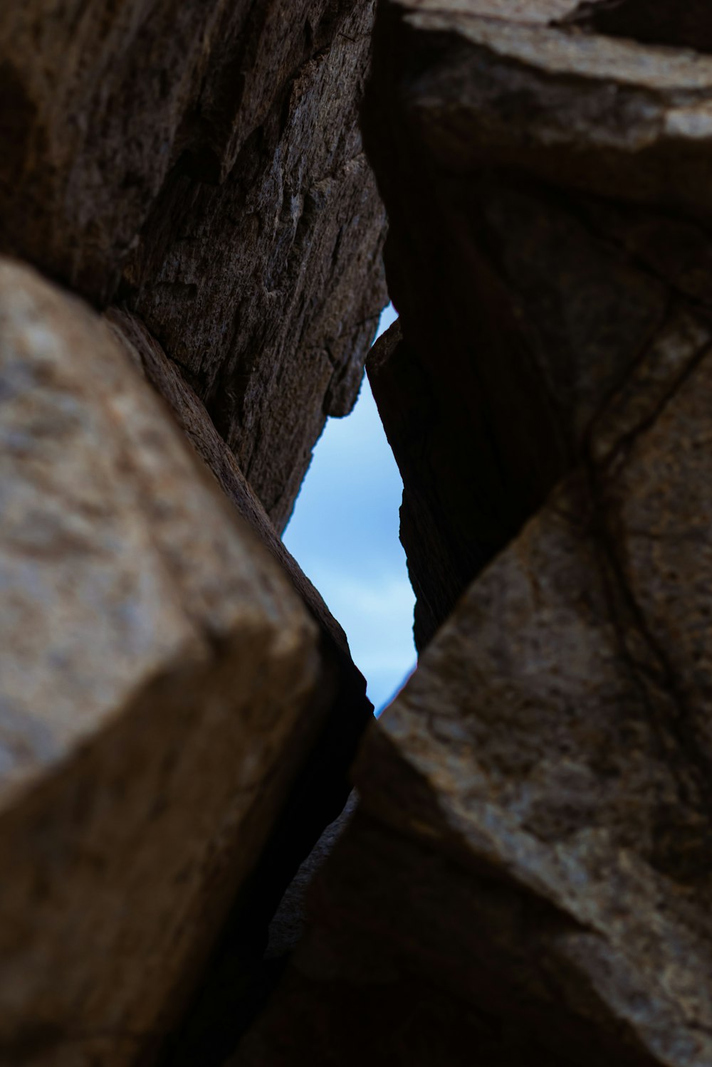 a rock formation with a blue sky in the background