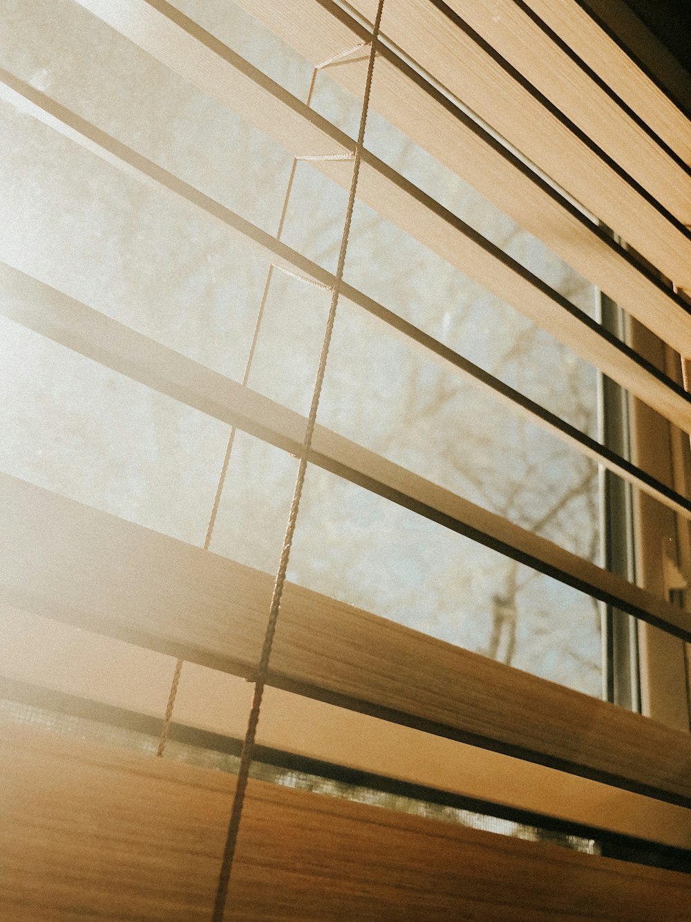 a close up of a closed window with blinds