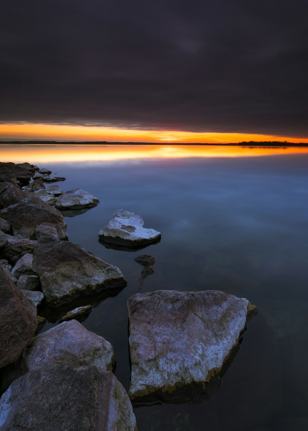 a long exposure photo of a sunset over a body of water