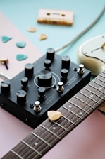 a close up of a guitar with a guitar picker