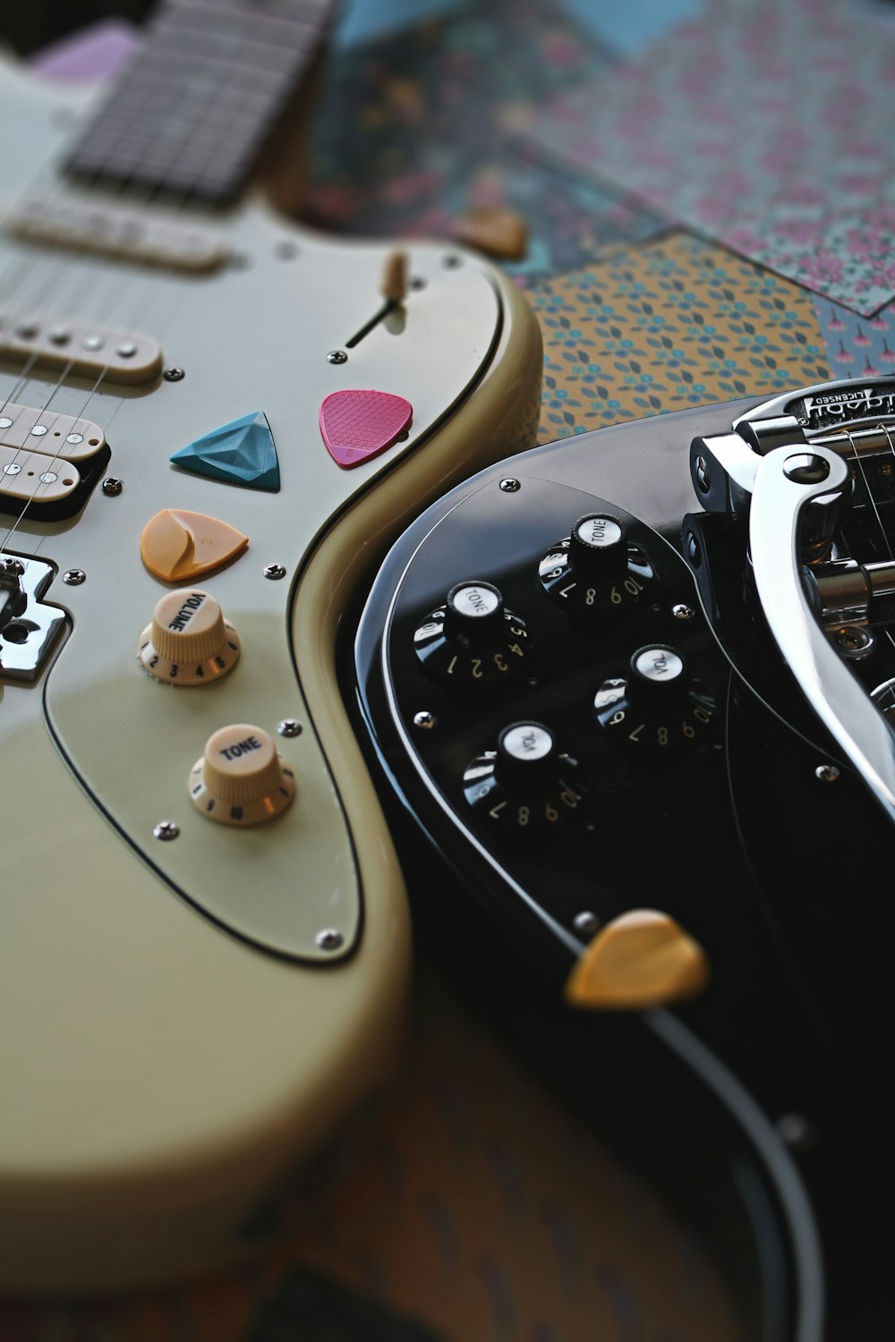a close up of two electric guitars on a table