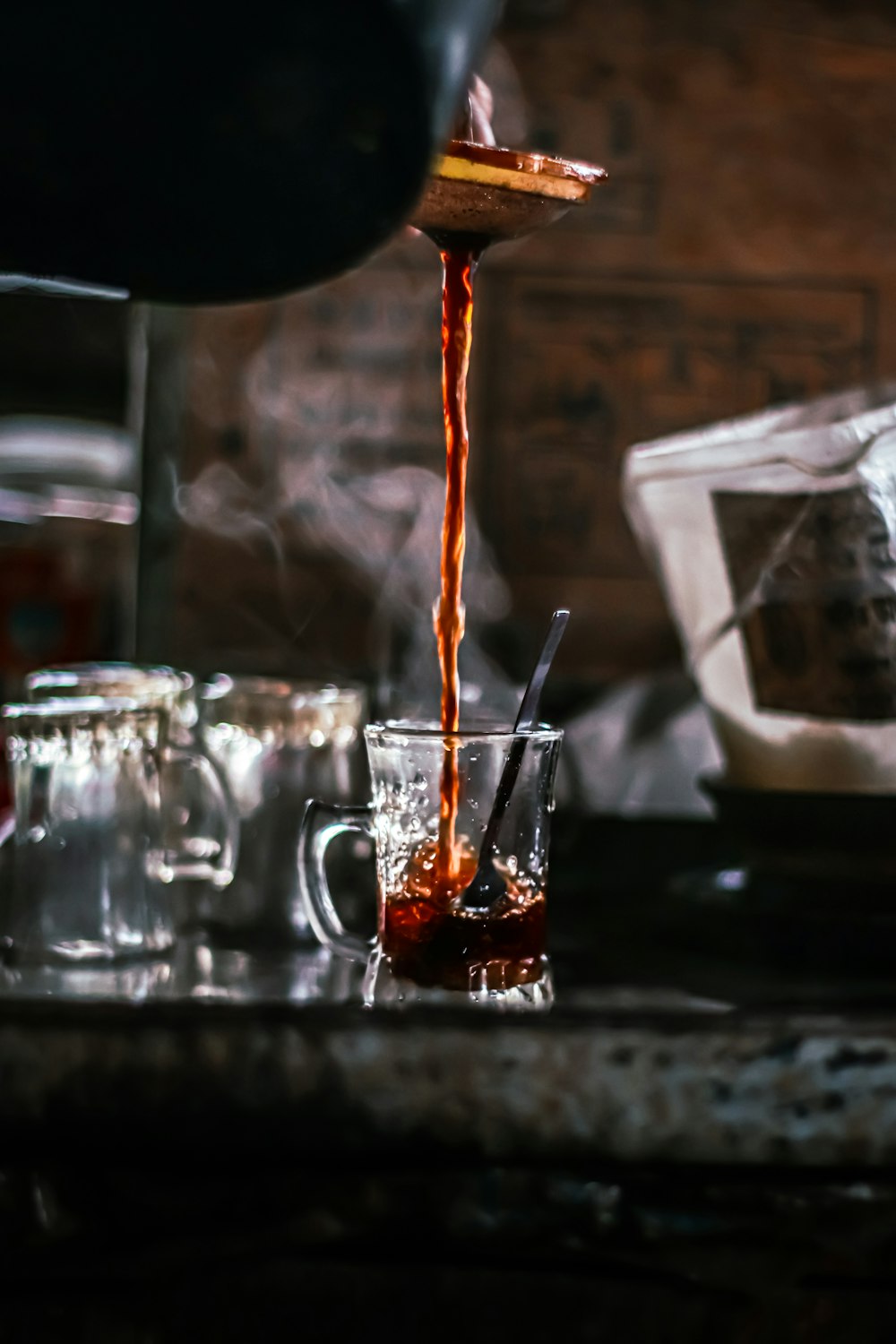 a person pouring a drink into a glass