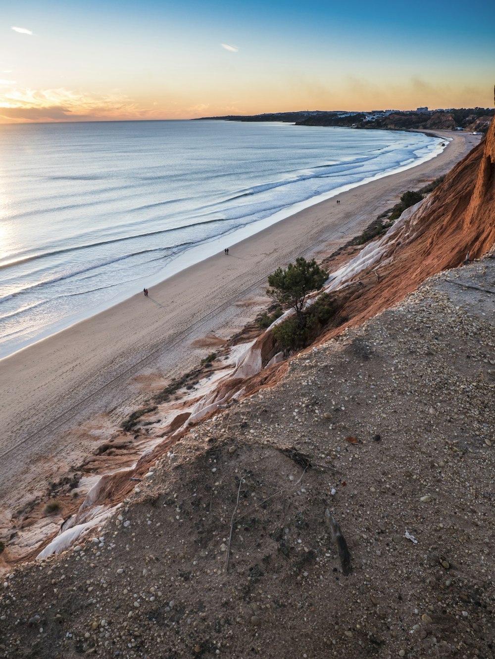 a view of a beach and the ocean at sunset