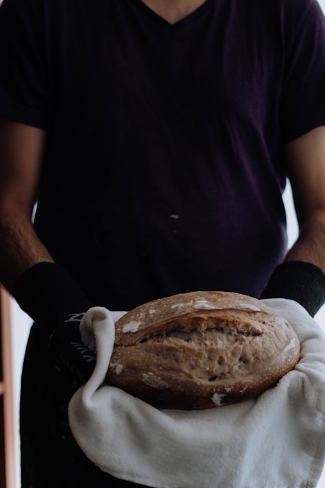 a man holding a loaf of bread in his hands