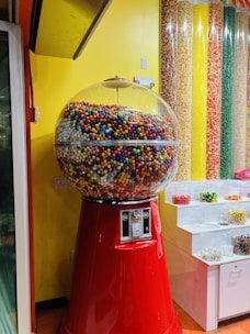 a large gummy machine sitting in front of a yellow wall