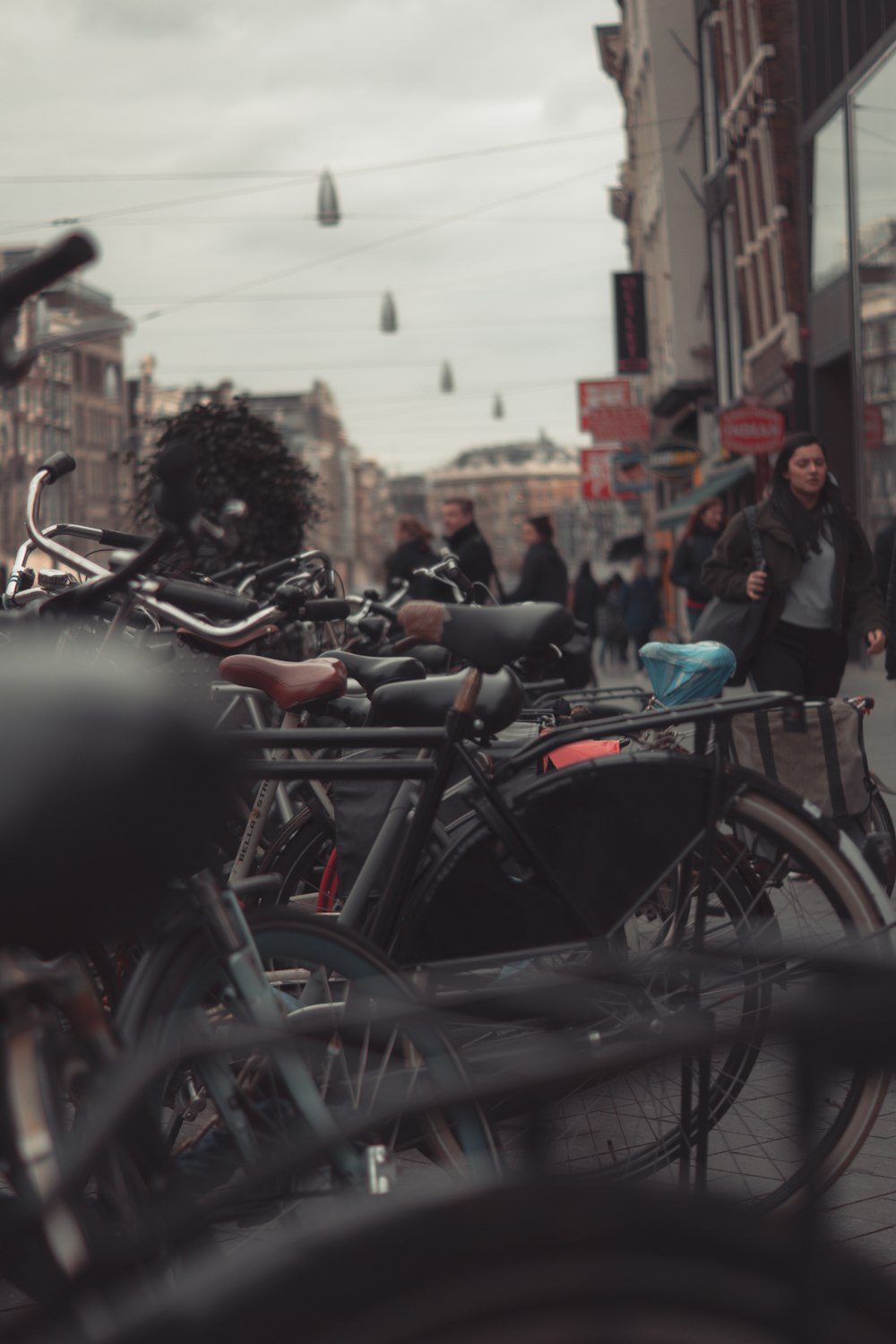 a group of bikes parked next to each other on a sidewalk