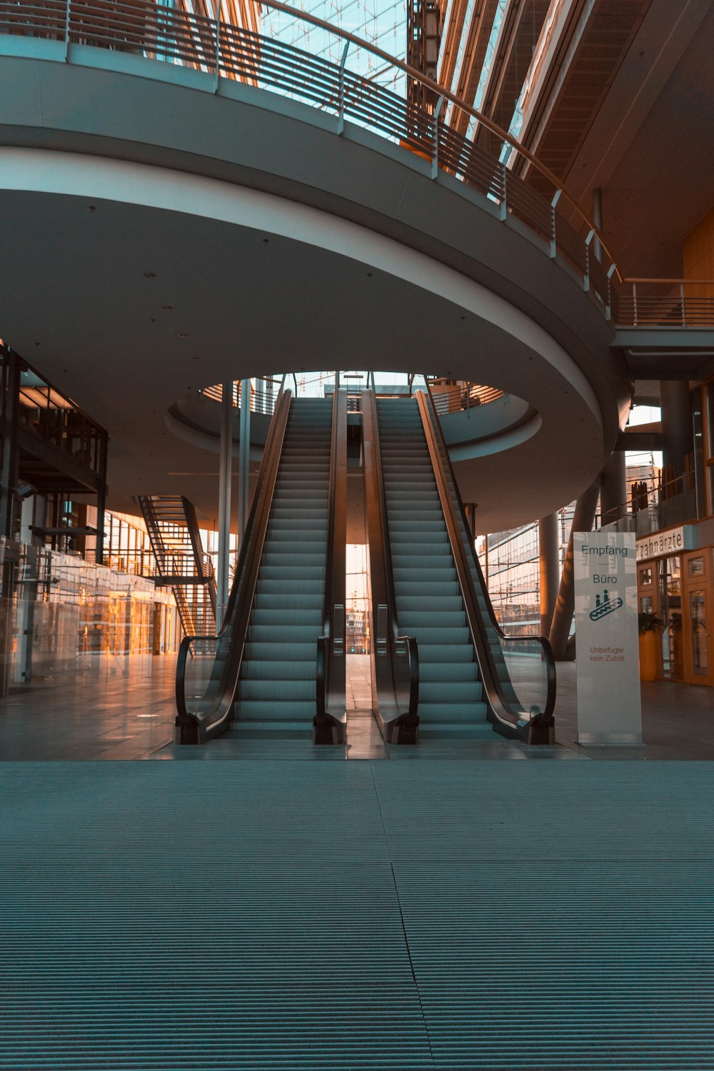 an escalator in a large building with a skylight