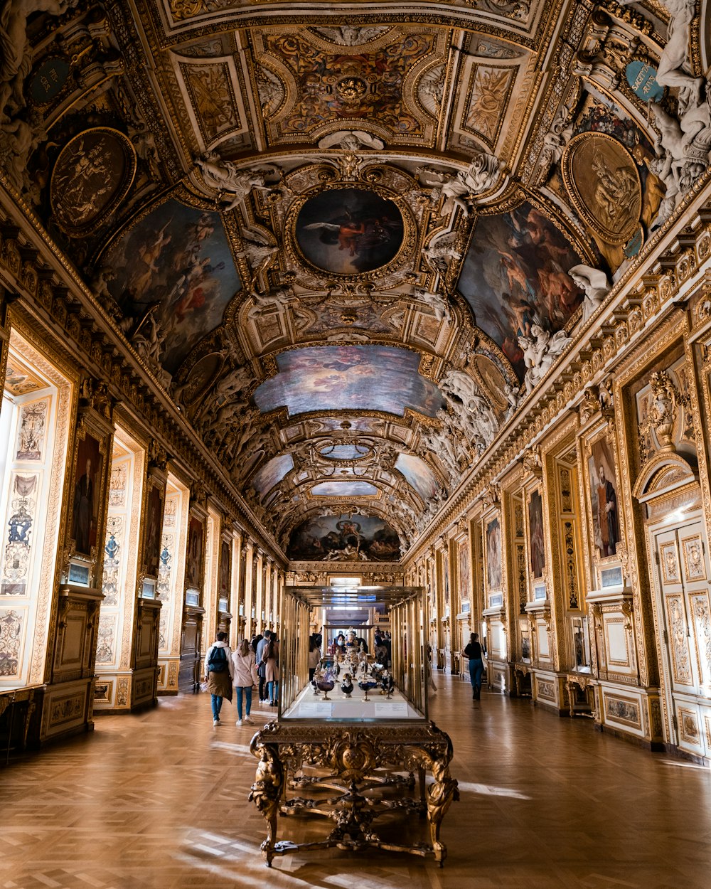 a long hallway with a painting on the ceiling