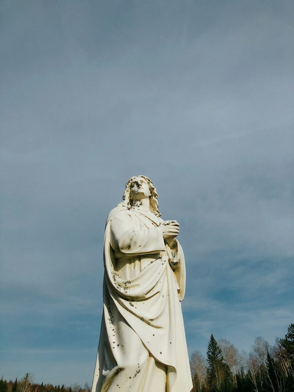 a large white statue of a man with a beard