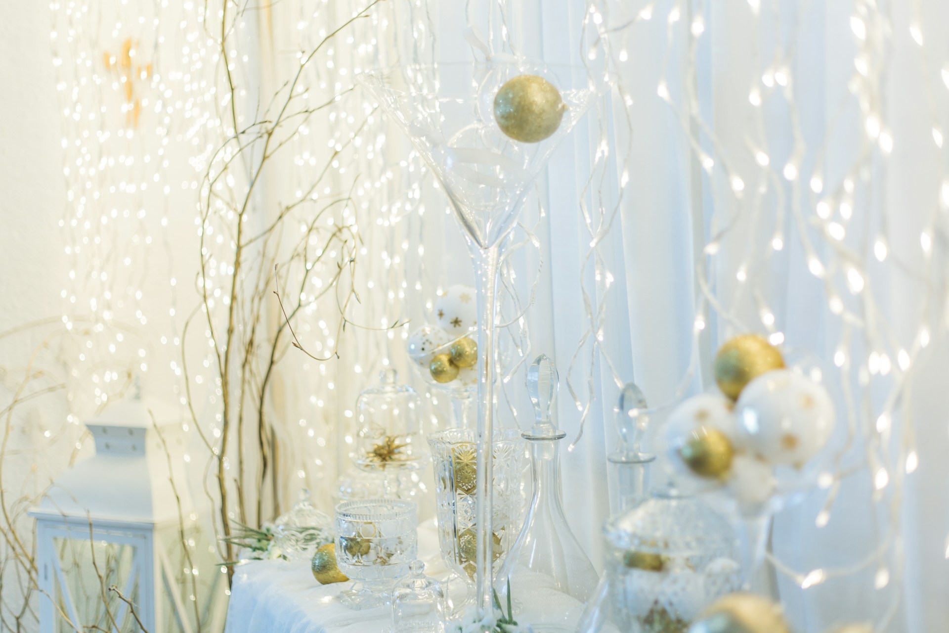 a white table topped with lots of glass vases