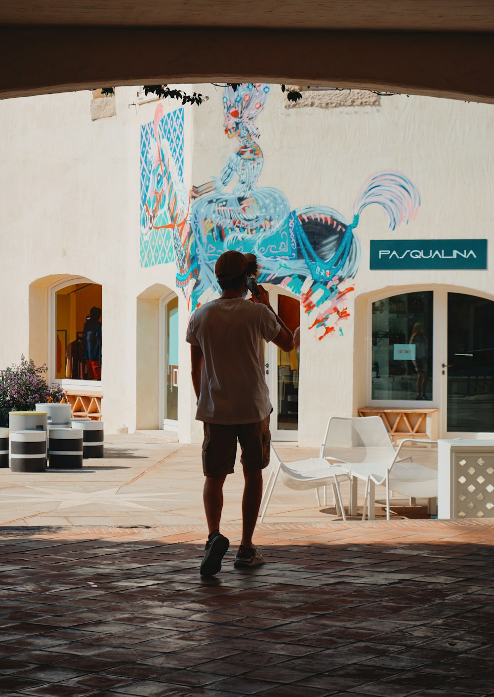 a man standing in front of a building holding a kite