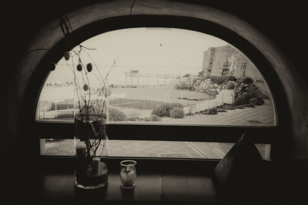 a vase of flowers sitting on a table next to a window