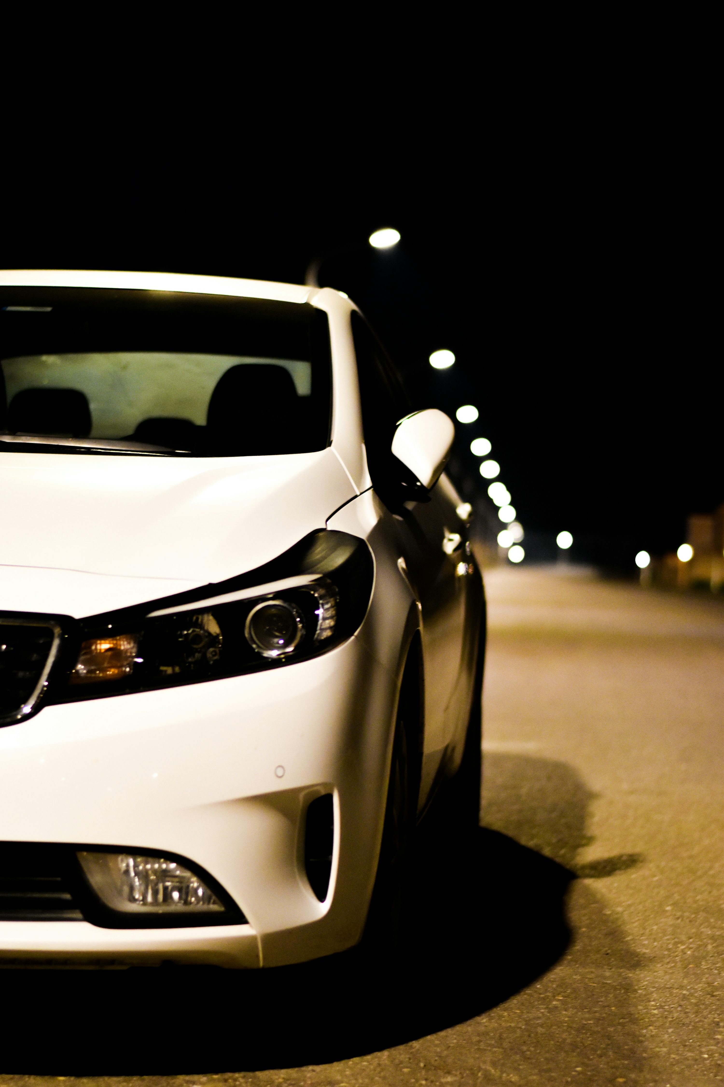 a white car parked on the side of the road