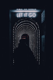 a dark tunnel with a sign that says let it go