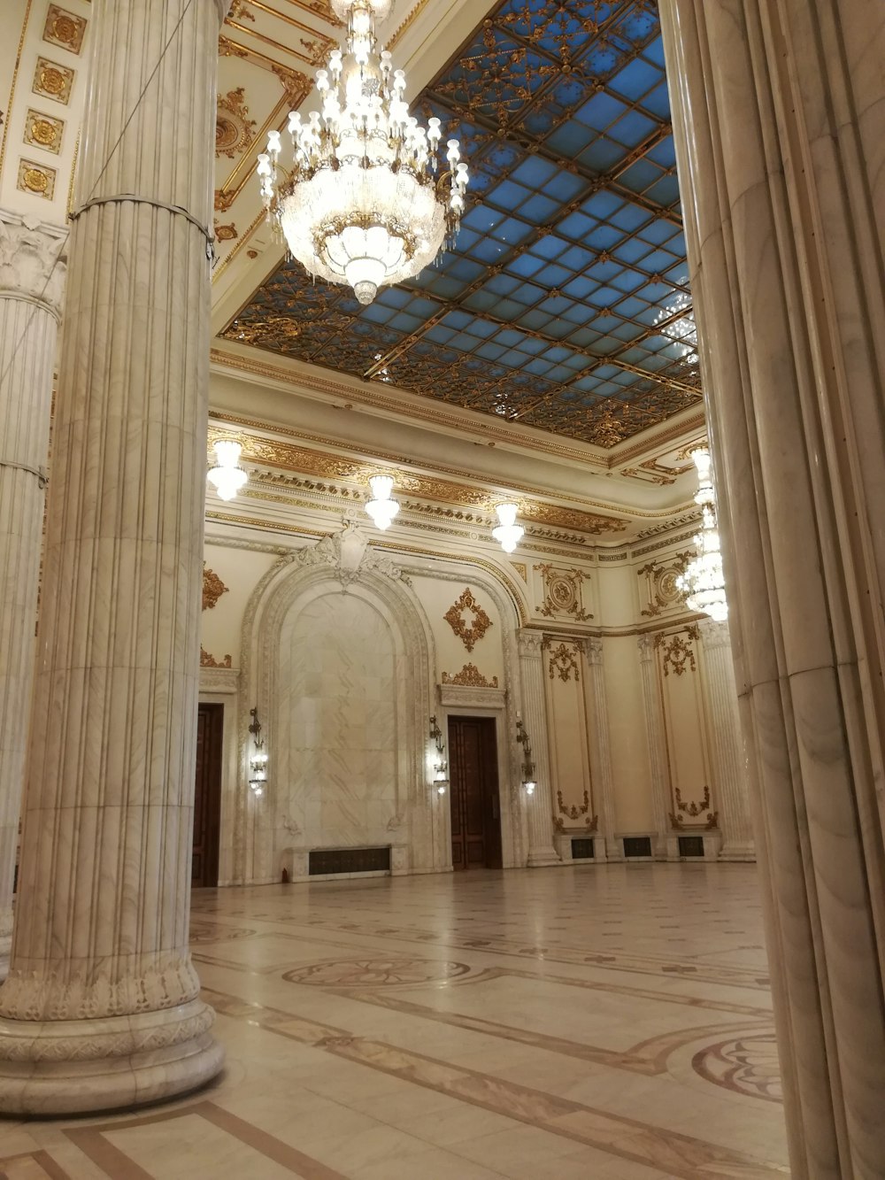 a chandelier hanging from the ceiling of a large room