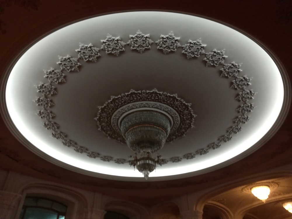 a circular ceiling with a chandelier and lights