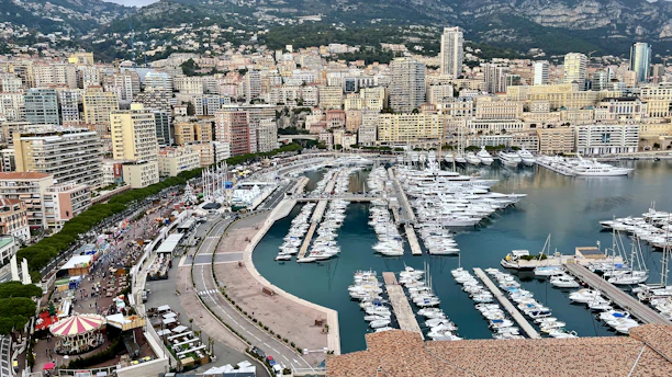 a harbor filled with lots of boats next to a city