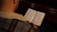 A police officer reading a Bible in a quiet park setting.