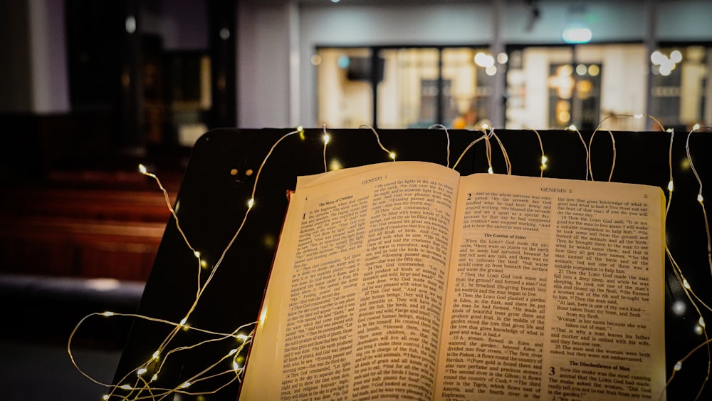 an open book sitting on top of a bench