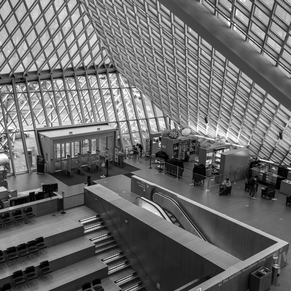 a black and white photo of an airport lobby