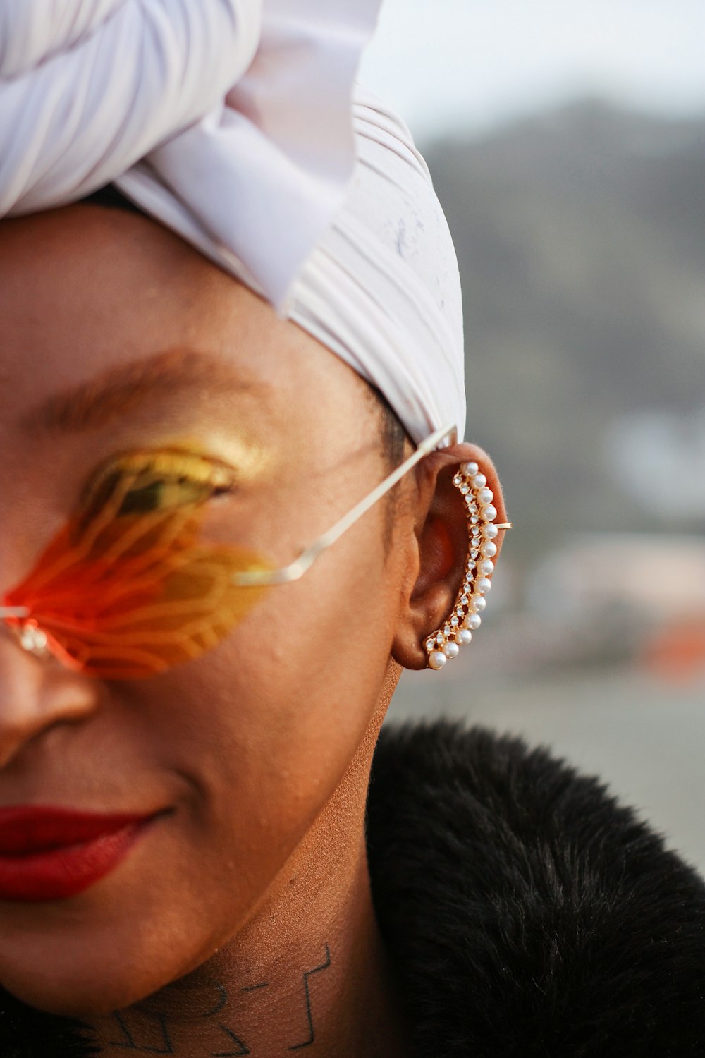 a close up of a person wearing a white headband