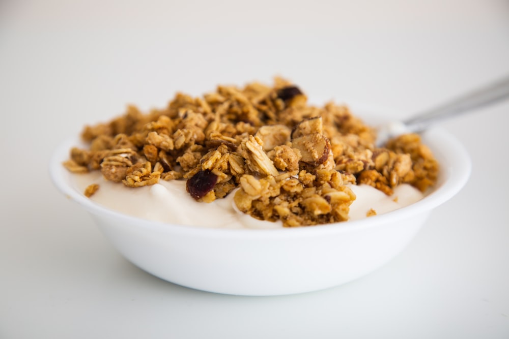 a bowl of granola and yogurt with a spoon