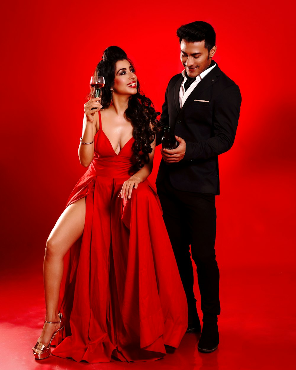 a woman in a red dress and a man in a black suit