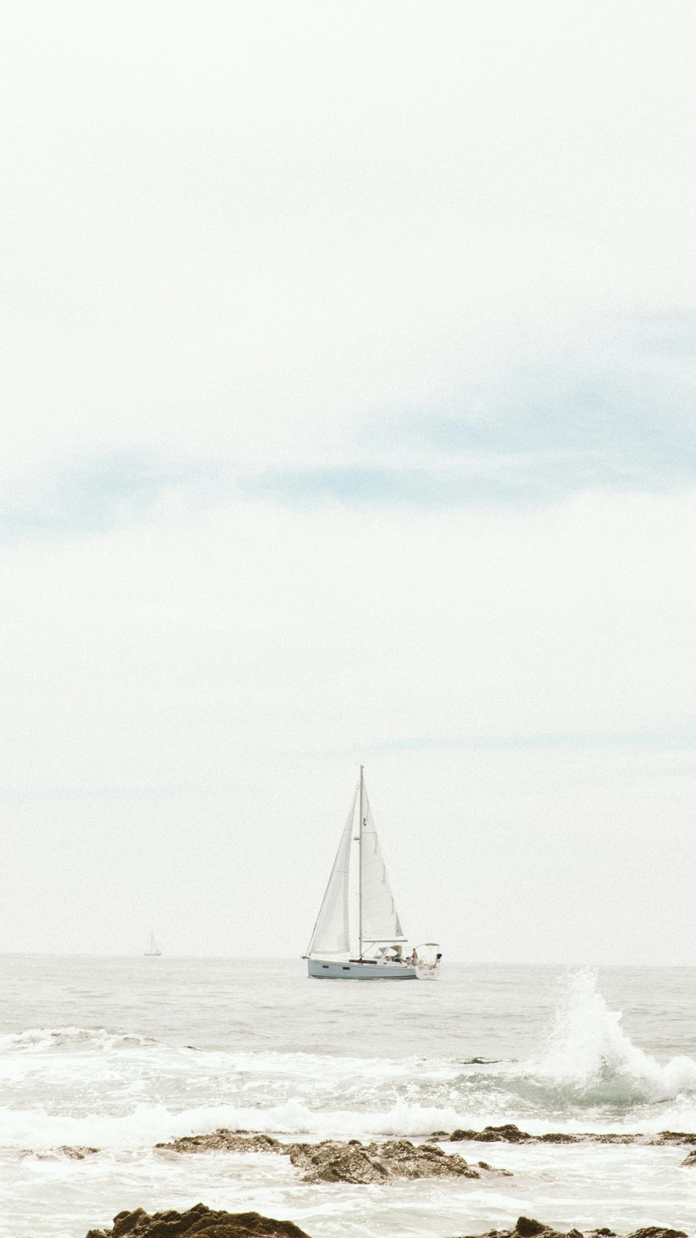 a sailboat is out on the ocean