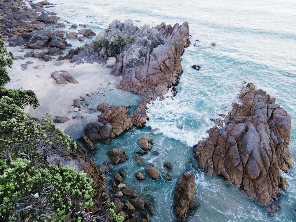 an aerial view of a rocky beach and ocean