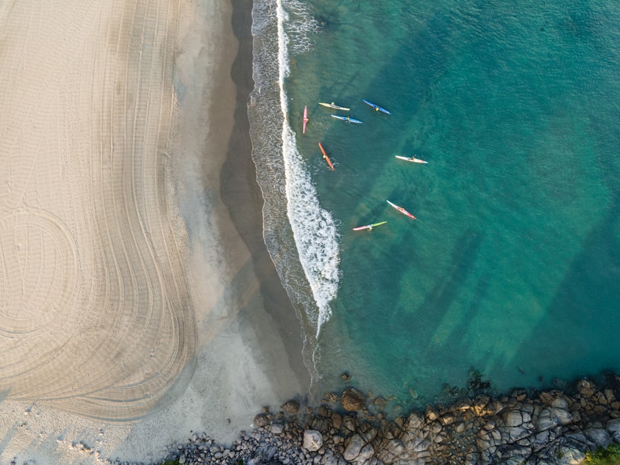 Kayakers setting off from calm sandy shore