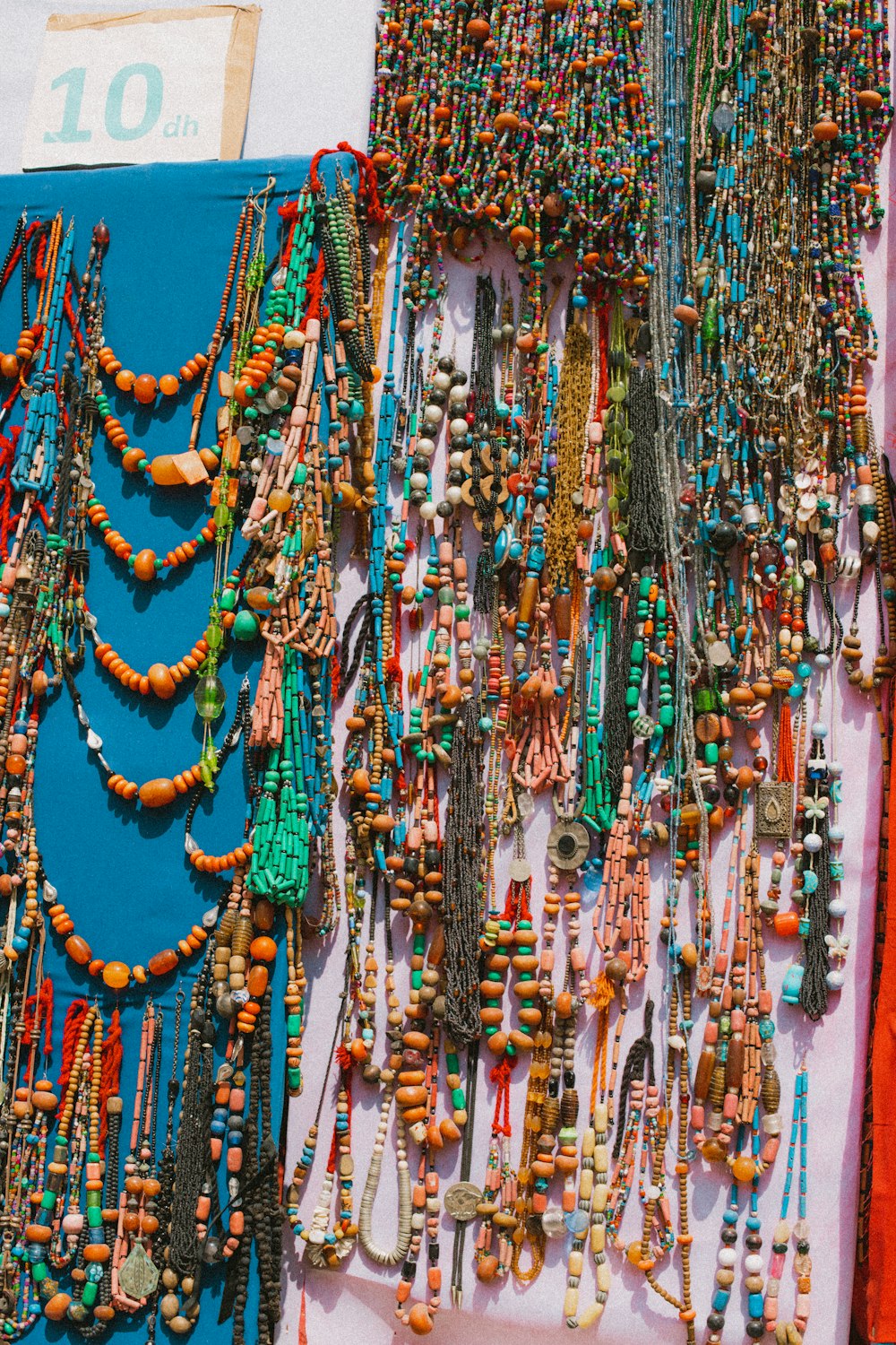 a bunch of necklaces that are on a table