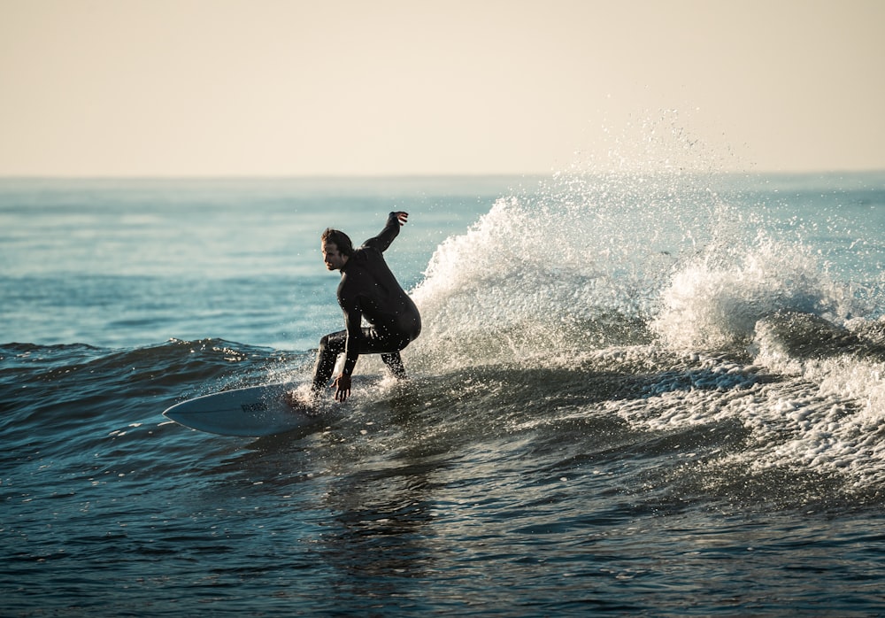 a person riding a surfboard on a wave in the ocean