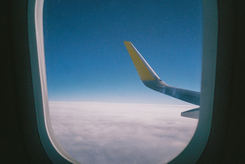 a view of the wing of an airplane through a window