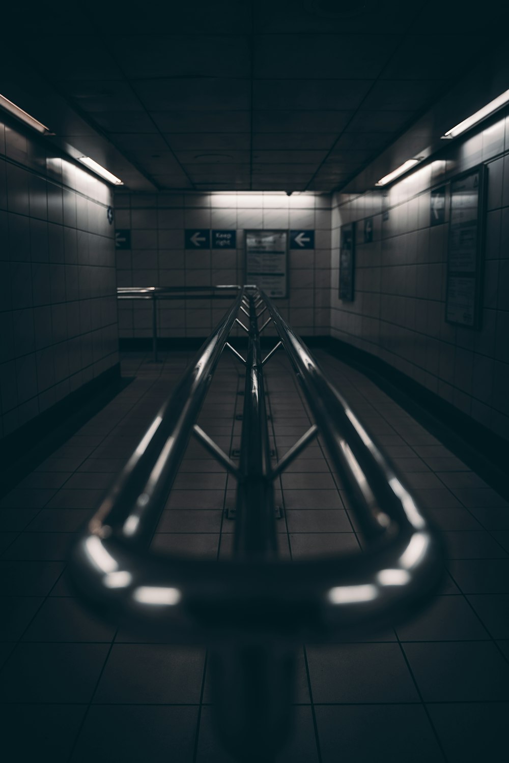 a long metal railing in a dark hallway